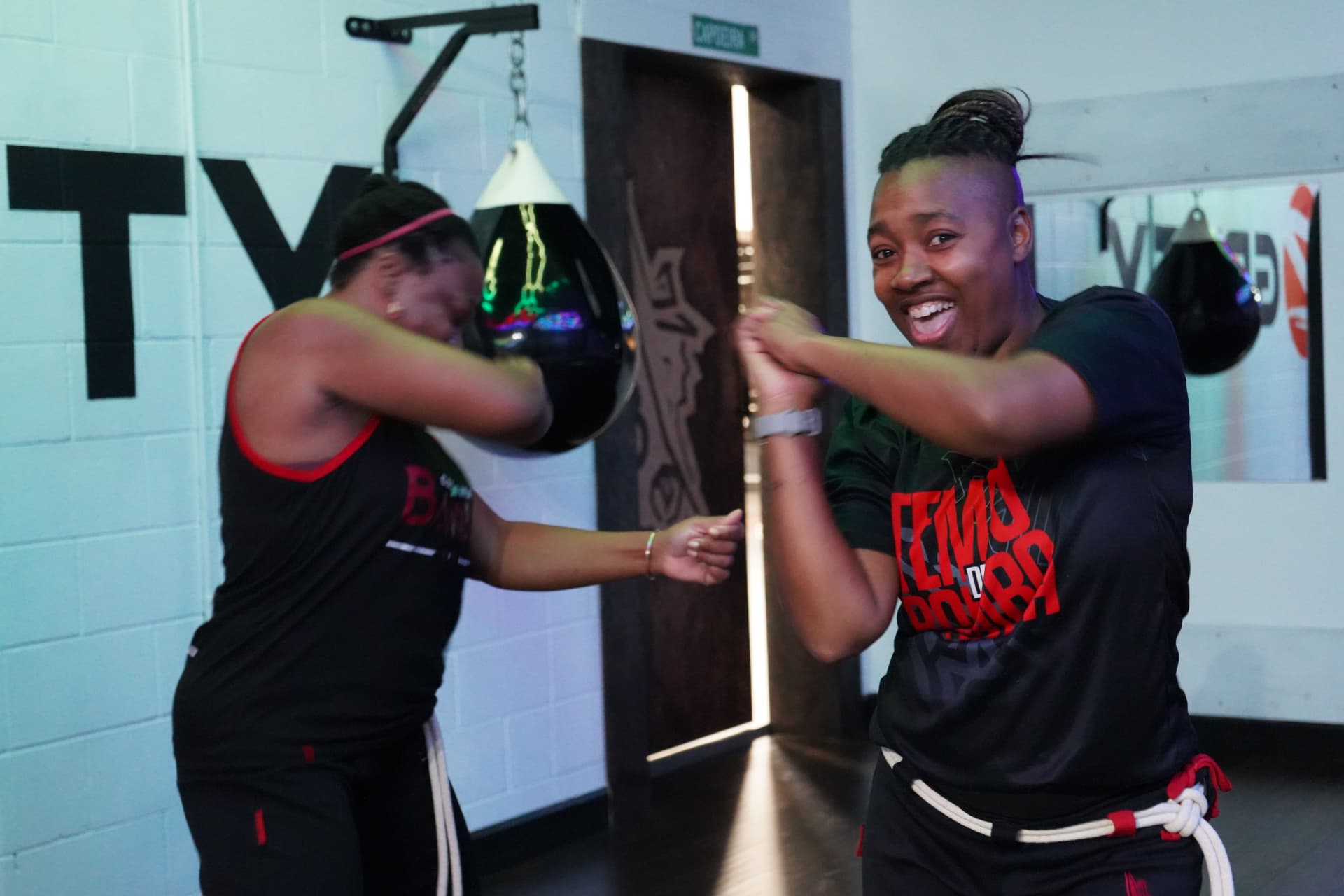 Two Capoeira Bamba students sharing a joyful training moment