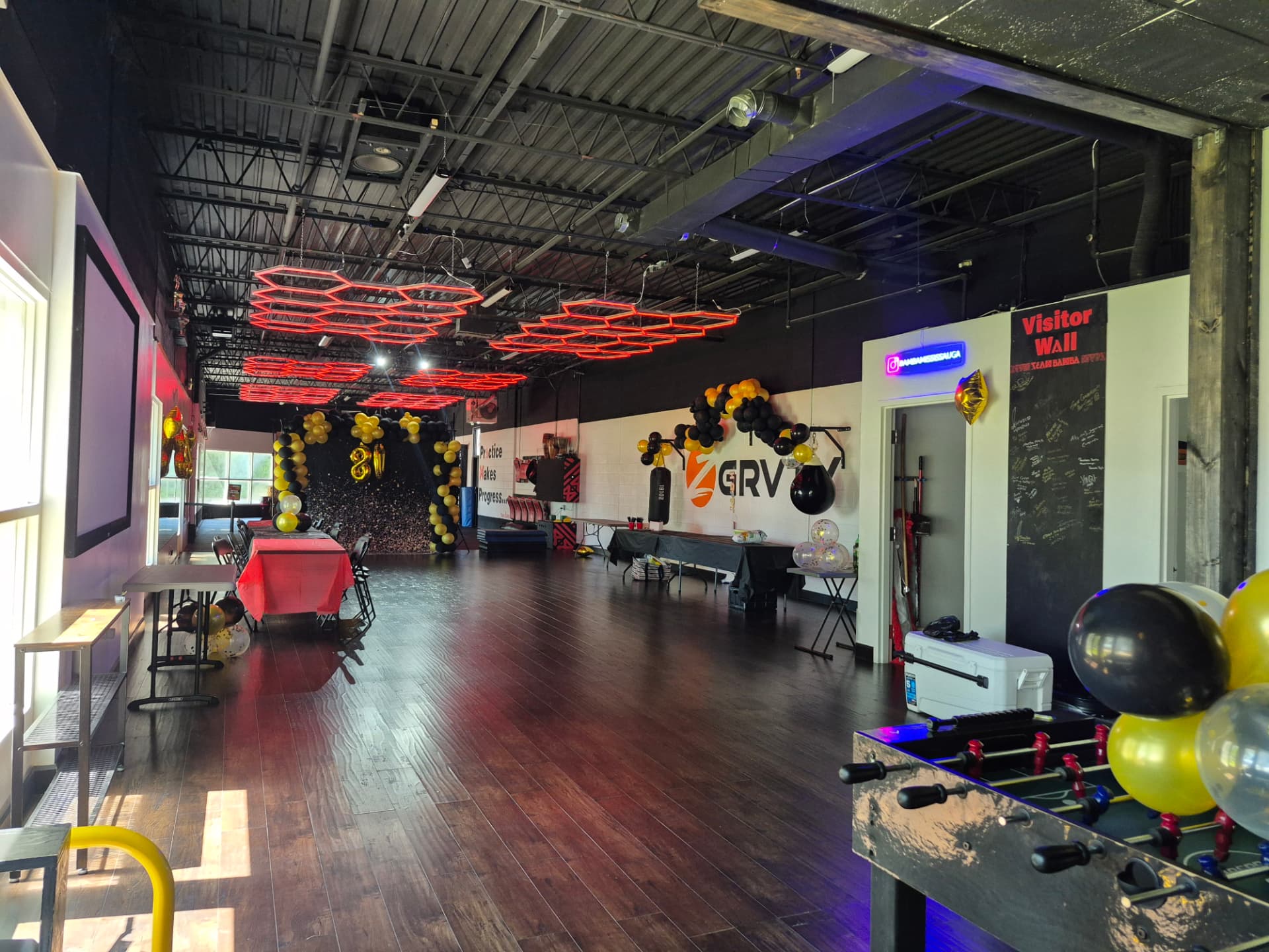 A wide private-event setup with tables, balloons and games at Z GRVTY