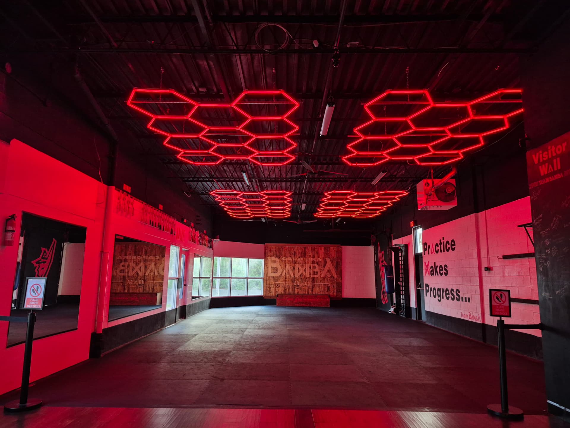The matted room prepared as a flexible private rental space under red LED lights