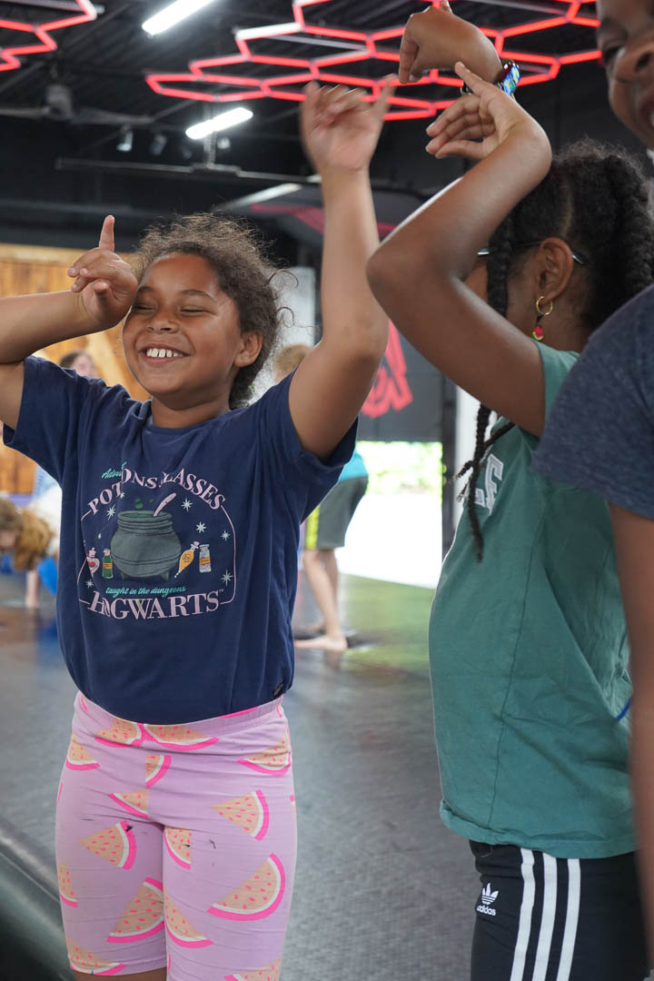Campers enjoying a movement activity under the hexagon lights