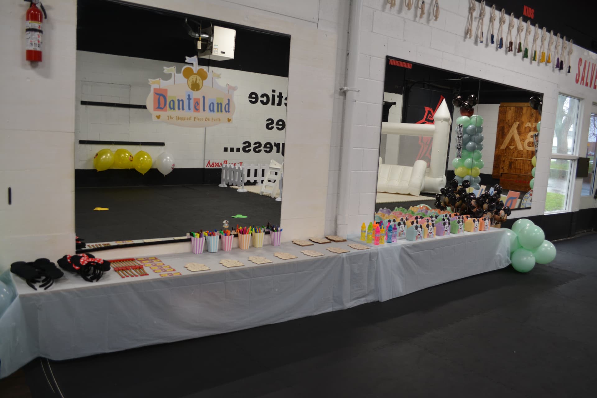 A decorated party table with balloons and an inflatable play area at Z GRVTY