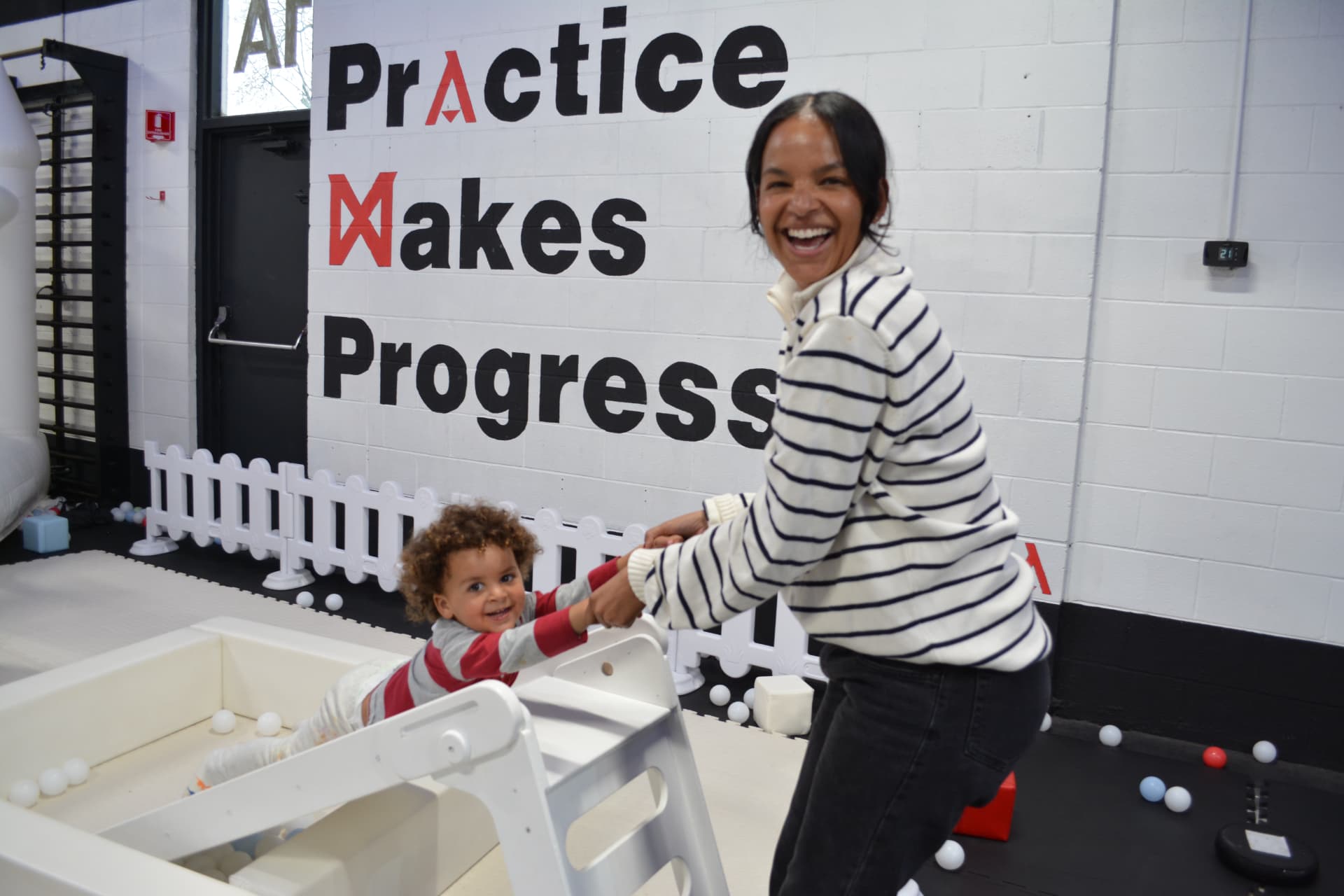 A parent and young child playing together during a private party at Z GRVTY