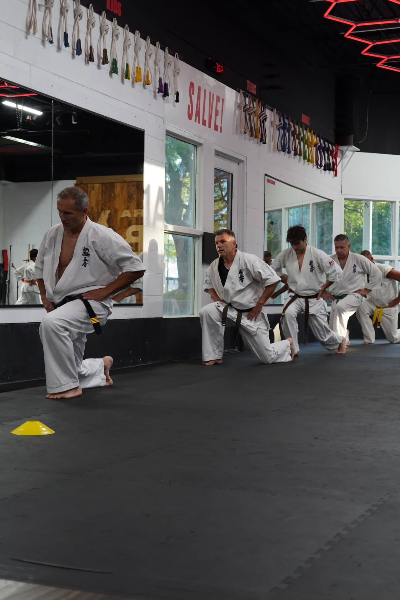 Kyokushin Karate students moving through a training drill on the mats